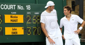 John Isner (L) of the USA poses with Nicolas Mahut (R) of France next to the scoring board after winning his first round match for the Wimbledon Championships at the All England Lawn Tennis Club, in London, Britain, 24 June 2010.  EPA/ALISTAIR GRANT / POOL  Reuters EDITORIAL USE ONLY/NO COMMERCIAL SALES