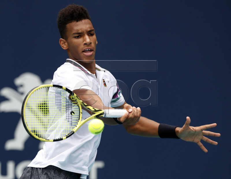 Felix Auger Aliassime of Canada in action against John Isner of the US during their men's semifinals match at the Miami Open tennis tournament in Miami, Florida, USA, 29 March 2019.  EPA-EFE/JASON SZENES