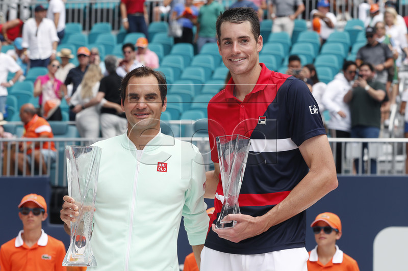 Roger Federer of Switzerland (L) and John Isner of the US (R) pose for a photo following their Men's finals match at the Miami Open tennis tournament in Miami, Florida, USA, 31 March 2019.  EPA-EFE/RHONA WISE
