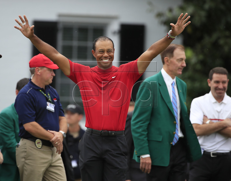 Tiger Woods of the US celebrates as he arrives to receive his fifth green jacket after winning the 2019 Masters Tournament at the Augusta National Golf Club in Augusta, Georgia, USA, 14 April 2019. The 2019 Masters Tournament is held 11 April through 14 April 2019. EPA-EFE/TANNEN MAURY