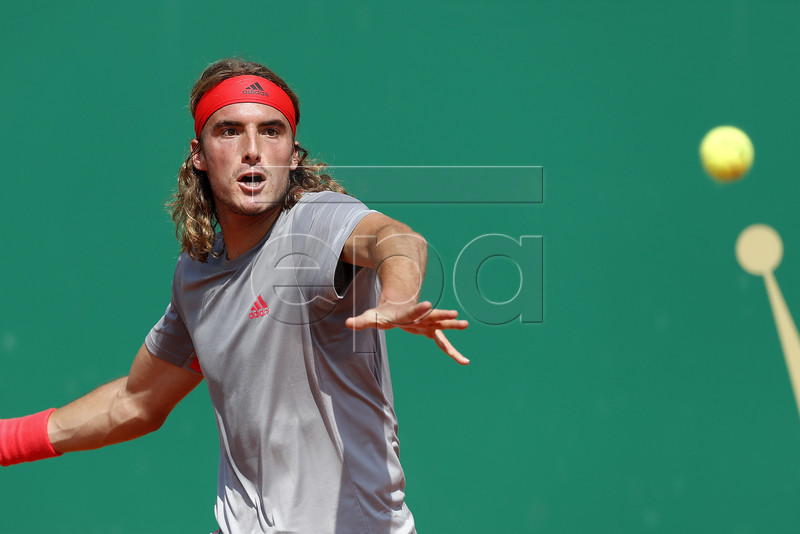 Stefanos Tsitsipas of Greece returns the ball to Daniil Medvedev of Russia during their third round match at the Monte-Carlo Rolex Masters tournament in Roquebrune Cap Martin, France, 18 April 2018.  EPA-EFE/SEBASTIEN NOGIER
