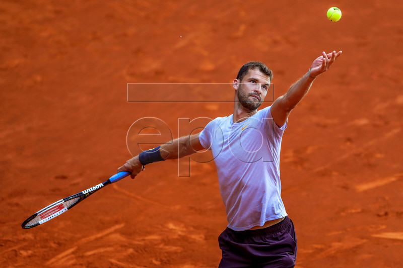 Grigor Dimitrov of Bulgaria in action against Taylor Fritz of the USA during their first round match of the Mutua Madrid Open tennis tournament at the Caja Magica complex in Madrid, Spain, 06 May 2019.  EPA-EFE/JUANJO MARTIN