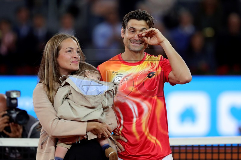 Spanish David Ferrer (R), accompanied by his wife Marta Tornel (L), receives a tribute after his Mutua Madrid Open's tournament round of 32 game against German Alexander Zverev played at Caja Magica tennis complex, in Madrid, Spain, 08 May 2019. This has been the last match of Ferrer as a professional tennis player. EPA-EFE/JUANJO MARTIN