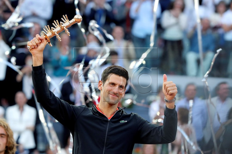 Novak Djokovic of Serbia celebrates with his trophy after winning the final match against Stefanos Tsitsipas of Greece at the Mutua Madrid Open tennis tournament, in Madrid, Spain, 12 May 2019.  EPA-EFE/KIKO HUESCA