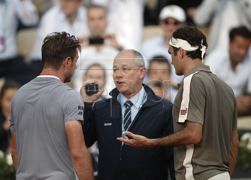 Roger Federer of Switzerland (R) and Stan Wawrinka of Switzerland (L) talk to an official as rain interupts their men?s quarter final match during the French Open tennis tournament at Roland Garros in Paris, France, 04 June 2019. EPA-EFE/YOAN VALAT