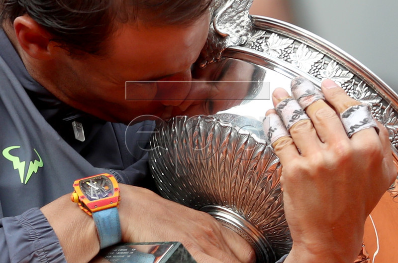 Rafael Nadal of Spain kisses the trophy after winning the men?s final match against Dominic Thiem of Austria during the French Open tennis tournament at Roland Garros in Paris, France, 09 June 2019. Nadal won the French Open title 12th times. EPA-EFE/SRDJAN SUKI