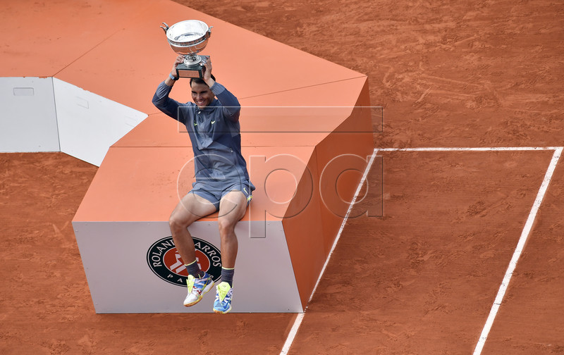 Rafael Nadal of Spain poses with the trophy after winning the men?s final match against Dominic Thiem of Austria during the French Open tennis tournament at Roland Garros in Paris, France, 09 June 2019. Nadal won the French Open title 12th times. EPA-EFE/JULIEN DE ROSA