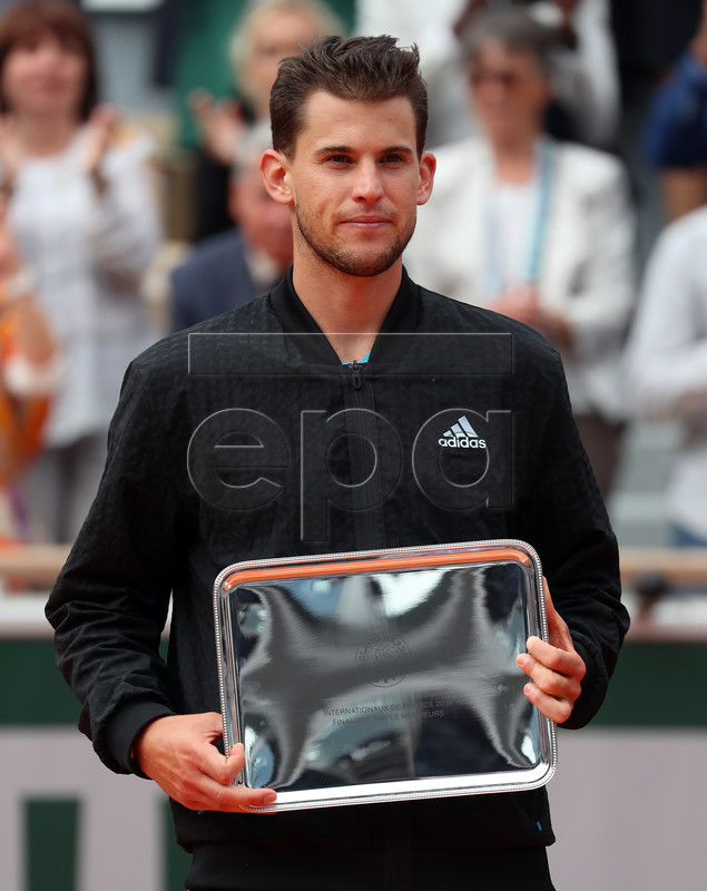 Dominic Thiem of Austria poses with the runner-up trophy after losing the men?s final against Rafael Nadal of Spain match during the French Open tennis tournament at Roland Garros in Paris, France, 09 June 2019. EPA-EFE/SRDJAN SUKI
