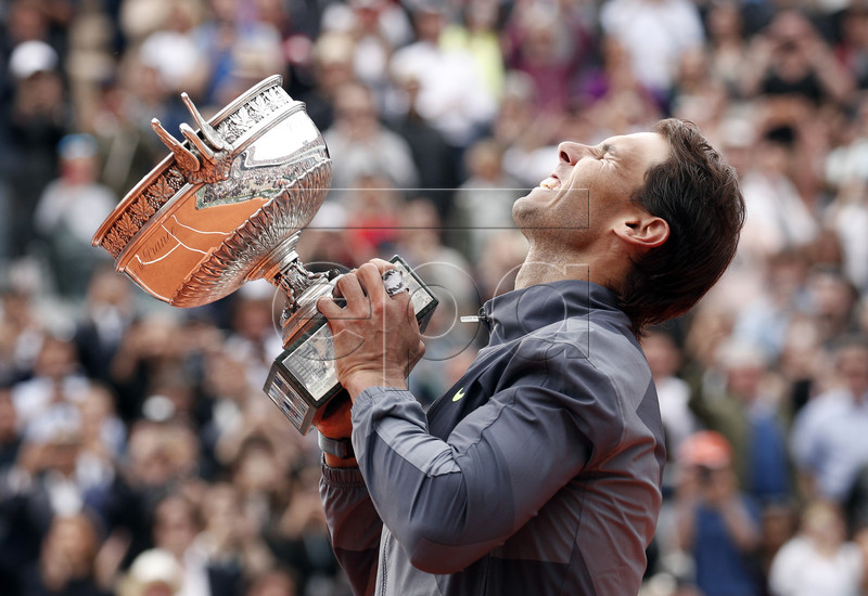 Rafael Nadal of Spain poses with the trophy after winning the men?s final match against Dominic Thiem of Austria during the French Open tennis tournament at Roland Garros in Paris, France, 09 June 2019. EPA-EFE/YOAN VALAT