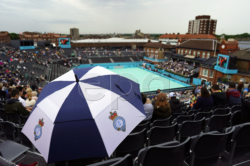 Spectators protect themselves from the rain during the second day of the Fever Tree Championships tennis tournament at Queen's Club in London, Britain, 18 June 2019. EPA-EFE/WILL OLIVER