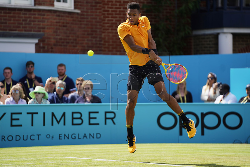 Canada's Felix Auger Aliassime in action against Greece's Stefanos Tsitsipas during their quarter final match at the Fever Tree Championship at Queen's Club in London, Britain, 21 June 2019. EPA-EFE/WILL OLIVER