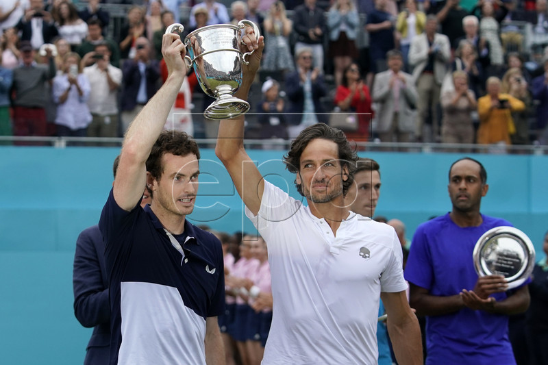 Britain's Andy Murray and Feliciano Lopez of Spain lift the championship trophy after winning their mens doubles final against Britain's Joe Salisbury and Rajeev Ram at the Fever Tree Championship at Queen's Club in London, Britain, 23 June 2019. EPA-EFE/WILL OLIVER