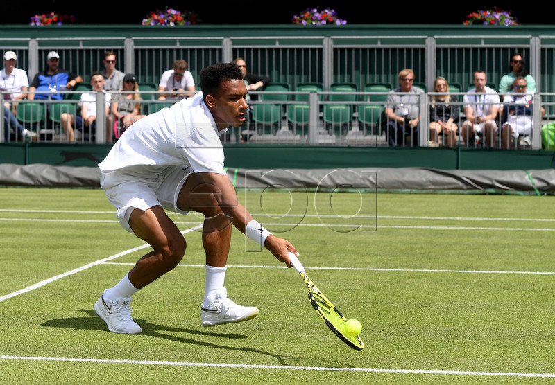 Felix Auger Aliassime from Canada in action against Vasek Pospisil of Canada during their first round match at the Wimbledon Championships at the All England Lawn Tennis Club, in London, Britain, 01 July 2019. EPA-EFE/FACUNDO ARRIZABALAGA EDITORIAL USE ONLY/NO COMMERCIAL SALES