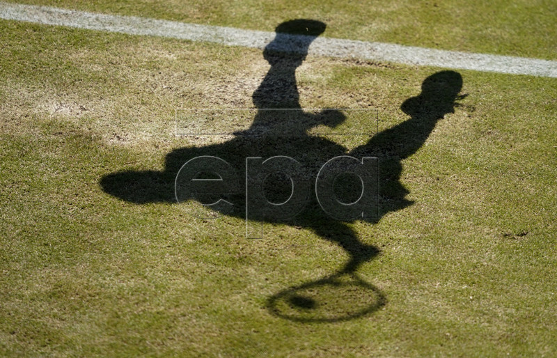 The shadow of Alison Van Uytvanck of Belgium in action against Ashleigh Barty of Australia during their second round match at the Wimbledon Championships at the All England Lawn Tennis Club, in London, Britain, 04 July 2019. EPA-EFE/NIC BOTHMA EDITORIAL USE ONLY/NO COMMERCIAL SALES