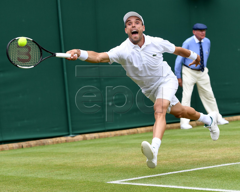 Roberto Bautista Agut of Spain in action against Benoit Paire of France during their fourth round match for the Wimbledon Championships at the All England Lawn Tennis Club, in London, Britain, 08 July 2019. EPA-EFE/FACUNDO ARRIZABALAGA EDITORIAL USE ONLY/NO COMMERCIAL SALES