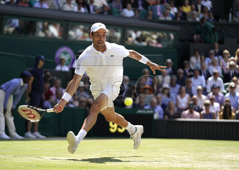 Roberto Bautista Agut of Spain in action against Novak Djokovic of Serbia during their semi final match for the Wimbledon Championships at the All England Lawn Tennis Club, in London, Britain, 12 July 2019. EPA-EFE/WILL OLIVER EDITORIAL USE ONLY/NO COMMERCIAL SALES