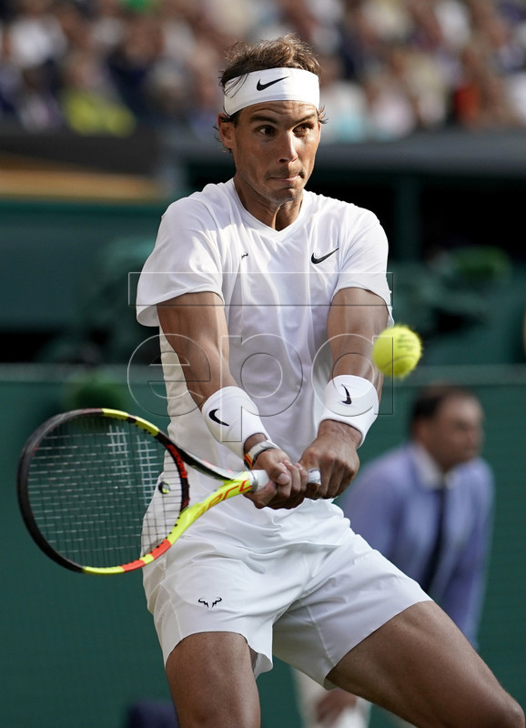 Rafael Nadal of Spain in action against Roger Federer of Switzerland during their semi final match for the Wimbledon Championships at the All England Lawn Tennis Club, in London, Britain, 12 July 2019. EPA-EFE/WILL OLIVER EDITORIAL USE ONLY/NO COMMERCIAL SALES