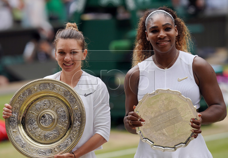 Simona Halep of Romania with the championship trophy as she celebrates her victory over Serena Williams of the US (R) in the women's final of the Wimbledon Championships at the All England Lawn Tennis Club, in London, Britain, 13 July 2019. EPA-EFE/WILL OLIVER EDITORIAL USE ONLY/NO COMMERCIAL SALES
