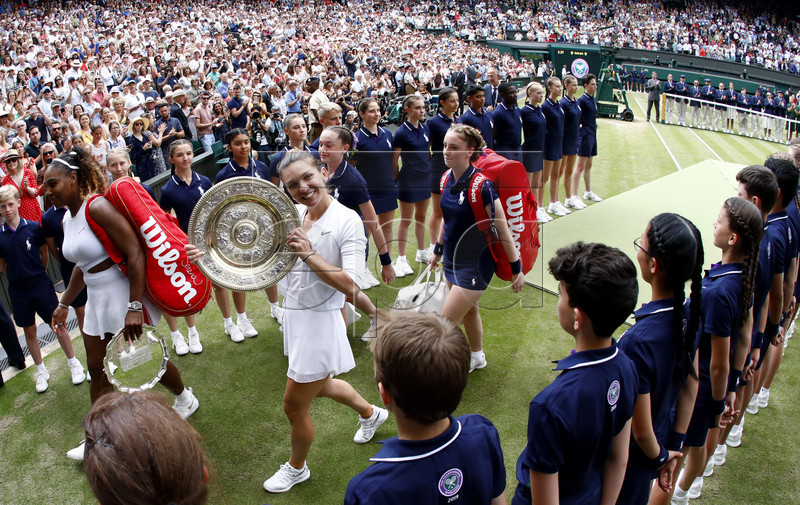 Simona Halep (C) of Romania celebrates with the trophy after winning against Serena Williams of the USA during their final match for the Wimbledon Championships at the All England Lawn Tennis Club, in London, Britain, 13 July 2019. EPA-EFE/NIC BOTHMA EDITORIAL USE ONLY/NO COMMERCIAL SALES