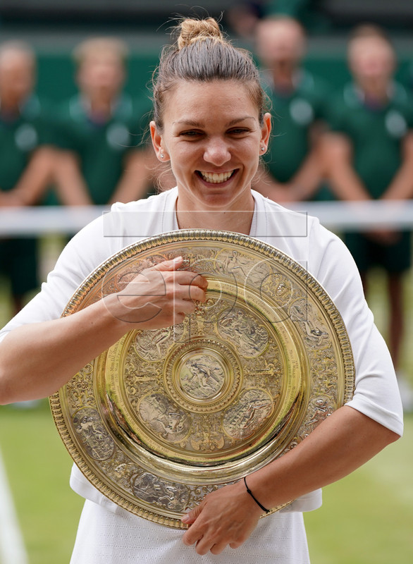 Simona Halep of Romania celebrates with the trophy after winning against Serena Williams of the USA during their final match for the Wimbledon Championships at the All England Lawn Tennis Club, in London, Britain, 13 July 2019. EPA-EFE/NIC BOTHMA EDITORIAL USE ONLY/NO COMMERCIAL SALES