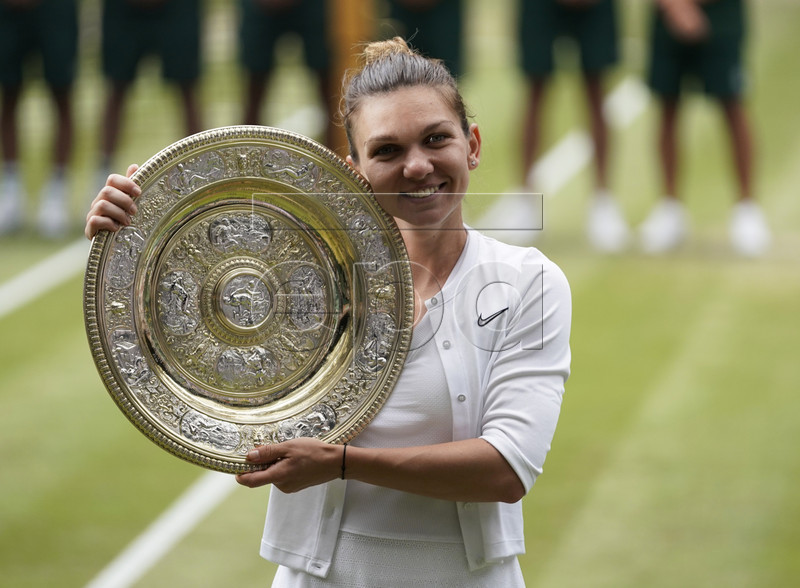 Simona Halep of Romania with the championship trophy as she celebrates her victory over Serena Williams of the US in the women's final of the Wimbledon Championships at the All England Lawn Tennis Club, in London, Britain, 13 July 2019. EPA-EFE/WILL OLIVER EDITORIAL USE ONLY/NO COMMERCIAL SALES