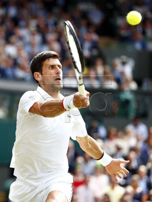 Novak Djokovic of Serbia returns to Roger Federer of Switzerland in the men's final of the Wimbledon Championships at the All England Lawn Tennis Club, in London, Britain, 14 July 2019. EPA-EFE/NIC BOTHMA EDITORIAL USE ONLY/NO COMMERCIAL SALES