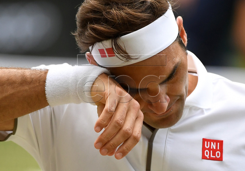 Roger Federer of Switzerland in action against Novak Djokovic of Serbia during their Men's final match for the Wimbledon Championships at the All England Lawn Tennis Club, in London, Britain, 14 July 2019. EPA-EFE/ANDY RAIN EDITORIAL USE ONLY/NO COMMERCIAL SALES