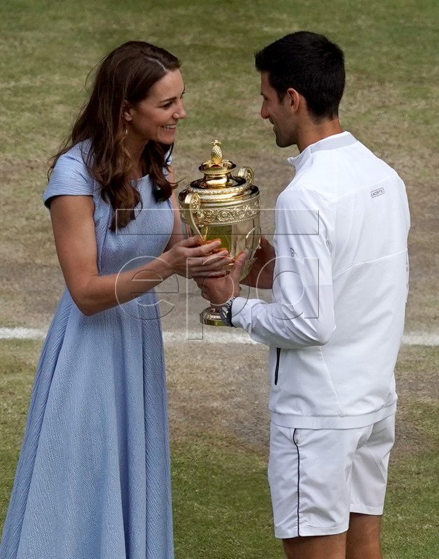 Novak Djokovic of Serbia receives the trophy from Catherine (L), the Duchess of Cambridge, after winning against Roger Federer of Switzerland during their Men's final match for the Wimbledon Championships at the All England Lawn Tennis Club, in London, Britain, 14 July 2019. EPA-EFE/WILL OLIVER EDITORIAL USE ONLY/NO COMMERCIAL SALES